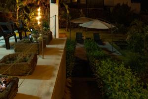 a garden at night with an umbrella and plants at Casa da Quinta in Vila Franca do Campo