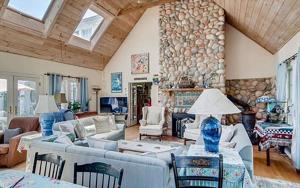 a living room filled with furniture and a stone wall at West Tisbury Inn in West Tisbury
