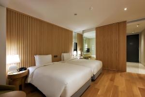 a bedroom with a large white bed in a room at Hotel Entra Gangnam in Seoul