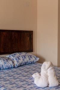 a bed with a made up towel animal on it at hotel isla Bonita in Zihuatanejo