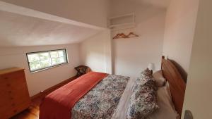 a bedroom with a bed and a window at Secluded Beach House @Praia da Galé in Melides