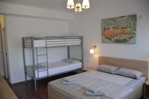 a bedroom with two bunk beds and a car picture at Casa Robinson in Vama Veche