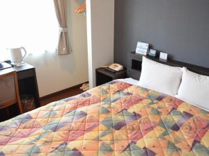 Ένα ή περισσότερα κρεβάτια σε δωμάτιο στο Yokohama Mandarin Hotel