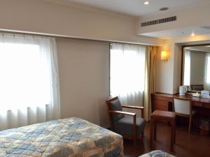 Ένα ή περισσότερα κρεβάτια σε δωμάτιο στο Yokohama Mandarin Hotel