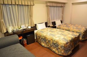 Ένα ή περισσότερα κρεβάτια σε δωμάτιο στο Yokohama Mandarin Hotel