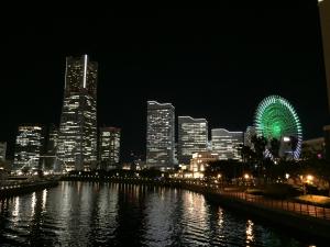 a city at night with a large clock tower at Yokohama Mandarin Hotel in Yokohama