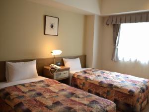 Ένα ή περισσότερα κρεβάτια σε δωμάτιο στο Yokohama Mandarin Hotel