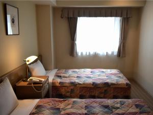 Ένα ή περισσότερα κρεβάτια σε δωμάτιο στο Yokohama Mandarin Hotel