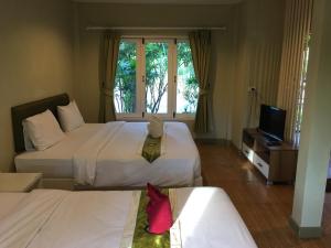 Posteľ alebo postele v izbe v ubytovaní Siriburi Resort