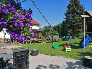 a backyard with a swing set and a playground at Urlaub beim Schmied in Kühlungsborn