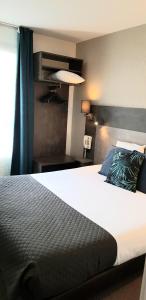 a bedroom with a large bed and a window at The Originals City, Hôtel Novella, Nantes Centre Gare in Nantes