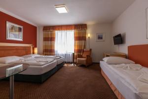 Letto o letti in una camera di Active & Wellness Hotel Subterra