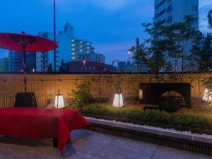 a table with a red table cloth and a fireplace at Tosei Hotel Cocone Asakusa Kuramae in Tokyo