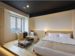 Postel nebo postele na pokoji v ubytování Tosei Hotel Cocone Asakusa Kuramae