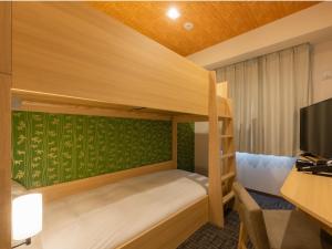 Postel nebo postele na pokoji v ubytování Tosei Hotel Cocone Asakusa Kuramae