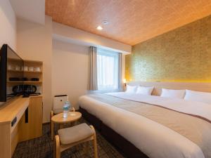 Postel nebo postele na pokoji v ubytování Tosei Hotel Cocone Asakusa Kuramae