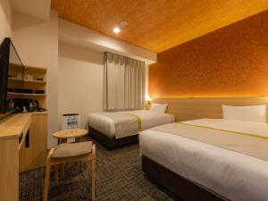 Postel nebo postele na pokoji v ubytování Tosei Hotel Cocone Asakusa Kuramae