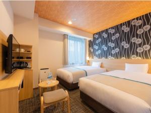 Postel nebo postele na pokoji v ubytování Tosei Hotel Cocone Asakusa Kuramae
