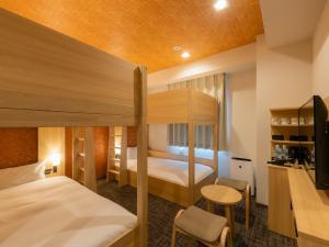 Postel nebo postele na pokoji v ubytování Tosei Hotel Cocone Asakusa Kuramae