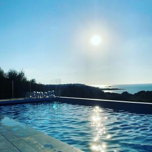 a swimming pool with a view of the ocean at Résidence Roc e Mare in LʼÎle-Rousse