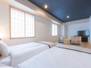 Postel nebo postele na pokoji v ubytování Tosei Hotel Cocone Asakusa Kuramae