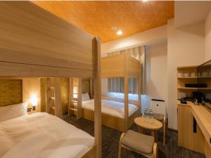 Postel nebo postele na pokoji v ubytování Tosei Hotel Cocone Asakusa Kuramae
