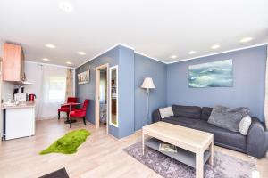 a living room with a couch and a table at Summer house in Ventspils