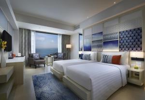 A bed or beds in a room at Amari Pattaya