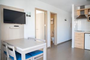 a small white table and chairs in a kitchen at Apartamentos Vistamar II in Playa d'en Bossa