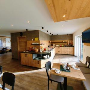uma grande cozinha com uma mesa e uma sala de jantar em B&B Gästehaus Alpenblick em Lermoos