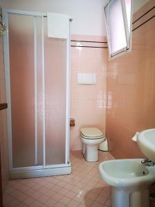 a bathroom with a shower and a toilet and a sink at Residence Rosa in Gabicce Mare