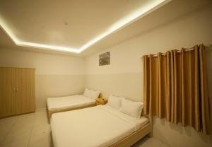 Postel nebo postele na pokoji v ubytování FaMi Nguyễn Homestay Châu Đốc