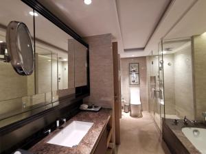a bathroom with two sinks and a shower and a toilet at Somerset Grandview Shenzhen in Shenzhen