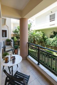 a balcony with a table and chairs and a view of a garden at Anastellar in Kissamos