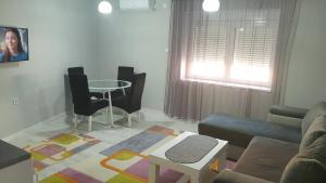 a living room with a couch and a table at Apartman Sweet dreams 2 in Niš