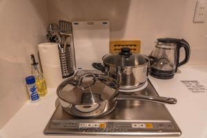 a stove with pots and pans on top of it at Hotel Sou Kyoto Gion in Kyoto