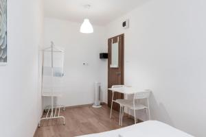 a room with a table, chairs and a lamp at Vajda 15 Hostel Budapest in Budapest