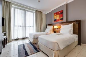 
A bed or beds in a room at Abidos Hotel Apartment Al Barsha
