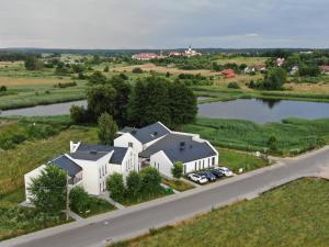 an aerial view of a house with a lake at Żabi Staw in Supraśl