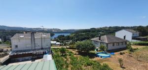 an aerial view of a house and a building at Apartamentos Portolux in Portomarin
