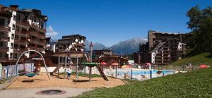 a playground with a slide and a swing at Résidence Christiana 109 Clés Blanches Courchevel in Courchevel