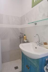 W łazience znajduje się umywalka i prysznic. w obiekcie Asiminas House w mieście Simi