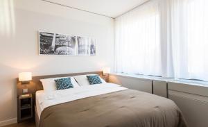 Cama ou camas em um quarto em Brera Serviced Apartments Frankfurt Oper