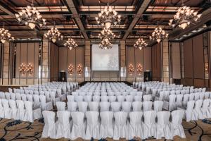 a large hall with white chairs and a screen at Four Seasons Hotel Hong Kong in Hong Kong +37 photos