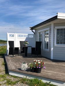 a house with a deck with a table and chairs at Oppmyre Camping in Myre