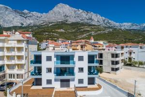 a group of buildings with mountains in the background at Delux Apartments Sunset Beach in Promajna
