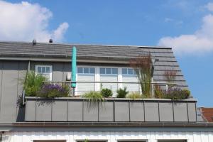 a house with a balcony with plants on it at Haus Selma in Zingst