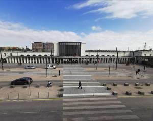 a large building with people walking in front of it at La Consigne Caen Gare SNCF Centre in Caen