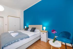 a blue bedroom with a bed and a blue wall at Hostel Globo in Šibenik