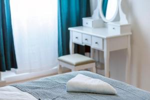 a bedroom with a bed with a mirror and a chair at Hostel Globo in Šibenik